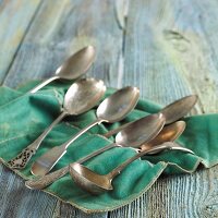 Assorted Silver Spoons on Felt Cloth