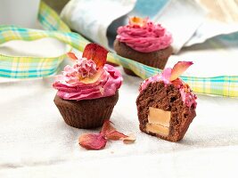 Chocolate cupcakes filled with caramel and topped with strawberry icing