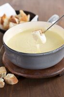 Cheese fondue with cubes of white bread
