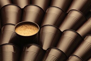 A cup of coffee surrounded by empty plastic cups