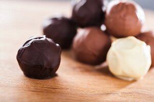 Assorted home-made chocolate truffles on a wooden table