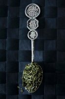 Sencha-Teeblätter auf orientalischem Silberlöffel