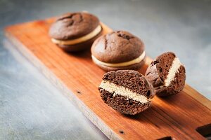 Whoopie Pies on a Wooden Board; One Halved
