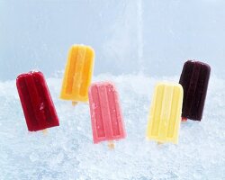 Assorted Fruit Popsicles Stuck in Crushed Ice