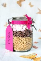 A preserving jar containing dry ingredients for making puffed rice and chocolate bars with marshmallows
