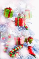 A Christmas tree with small parcels as decorations, and with candy canes