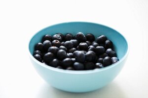 A bowl of blueberries on a white background