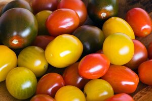 Yellow, red and black cherry tomatoes (filling the image)