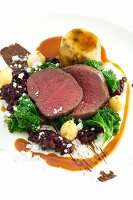 Medallions of venison with kale and cranberries