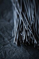 Squid ink spaghetti on black slate (close-up)