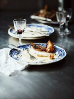 The remains of roast chicken with lemons, onions and thyme, on plates