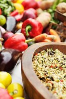 Fresh vegetables and a wooden bowl with buckwheat and vegetables