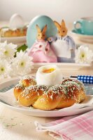 A soft-boiled egg in a bread wreath for breakfast on Easter Day