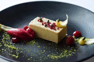 A slice of pistachio cake with raspberry sorbet