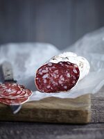 Salami, sliced, on a piece of paper