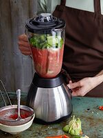 Vegetables for gazpacho being puréed in a mixer