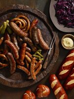 Sausages with gherkins, lye bread rolls, mustard and red cabbage