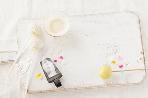 Glaze, edible flowers and sugar pearls for decorating cake pops