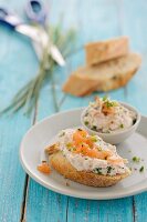 A slice of baguette topped with salmon cream