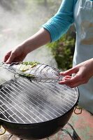 A fish being grilled in a fish basket