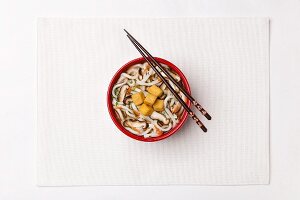 Wheat ﬂour noodle soup with carrots, mushroom, diced tofu and Spring onions (Japan)