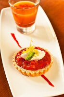 A strawberry and rhubarb tartlet with whipped cream