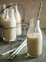 Almond milk in a glass bottle with a straw