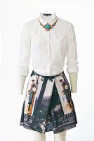 A white blouse, a statement necklace and a photo-print skirt