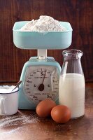 An arrangement of baking ingredients and a pair of kitchen scales