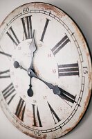 Station clock with vintage face mounted on wall