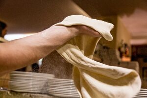 Pizza dough being stretched