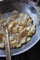 Fried rice crackers i a wok (Thailand)