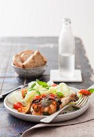 Marinated chicken legs with herbs, salad and bread