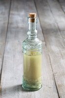 A decorative glass bottle for homemade preserves as a gift