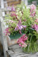 Glass vase of pink lupins