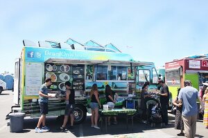 People buying fast food at a food truck festival in California, USA