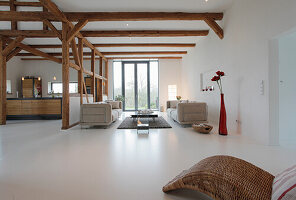 Loft-style living room with exposed wooden beams and designer furniture