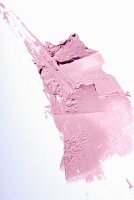 Pink lipstick on a white surface