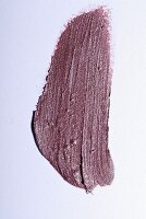 Old-rose lipstick on a white surface