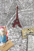 A map of Paris decorated with souvenirs and postcards