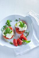 Herb bread rolls topped with mozzarella and tomatoes