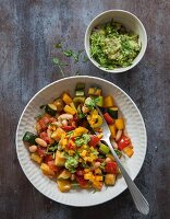 Colourful fried vegetables with an avocado dip and a mango and chilli salsa