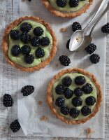 Vegan blackberry tartlets with avocado and soya cream