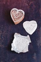 A heart-shaped stamp embossed in aluminium foil