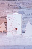 A homemade Christmas card decorated with paper Christmas trees