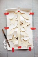 A paper garland being cut out