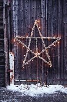 Star made from branches and Icelandic moss strung with fairy lights