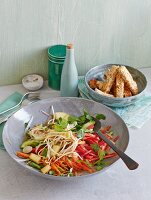 Mixed, oriental vegetable salad with mung bean sprouts served with tofu and sesame seed sticks