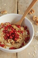 Vegan coconut yoghurt with oats, walnuts, pomegranate seeds and agave syrup