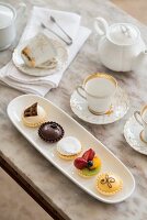 A table laid with petit fours and tea